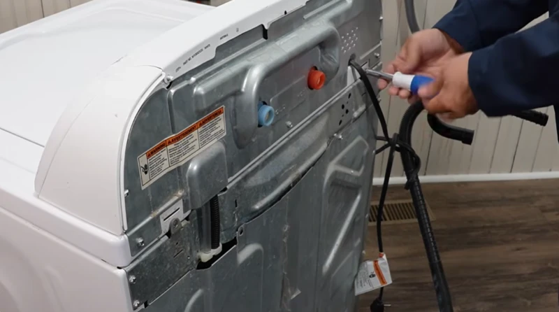 A Professional washer repair technician working on a washing machine inside a clean California home